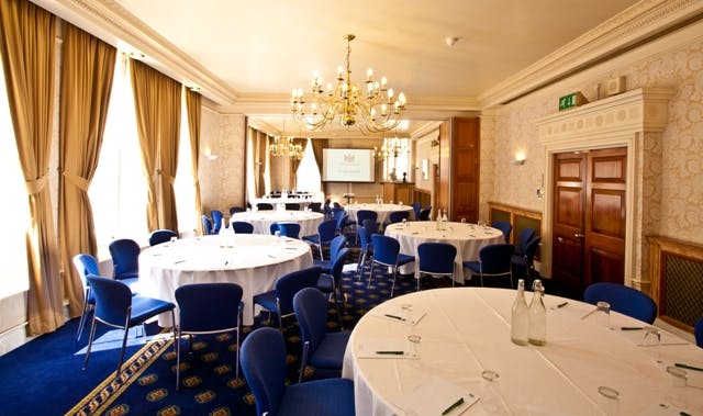 Elegant meeting room with round tables, ideal for corporate events and conferences.