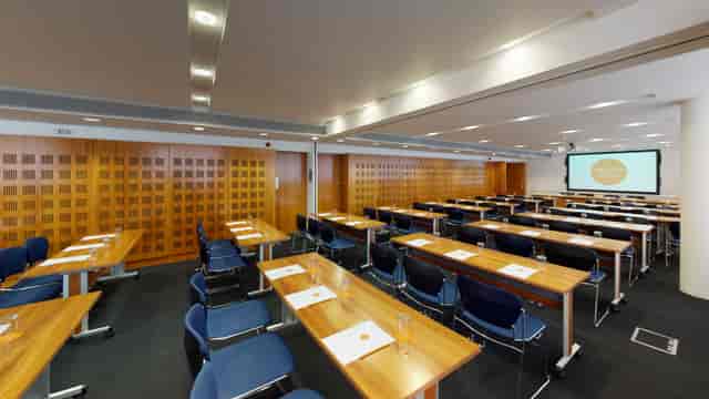 Invision Suite 4 meeting room with tables, chairs, and natural light for professional events.