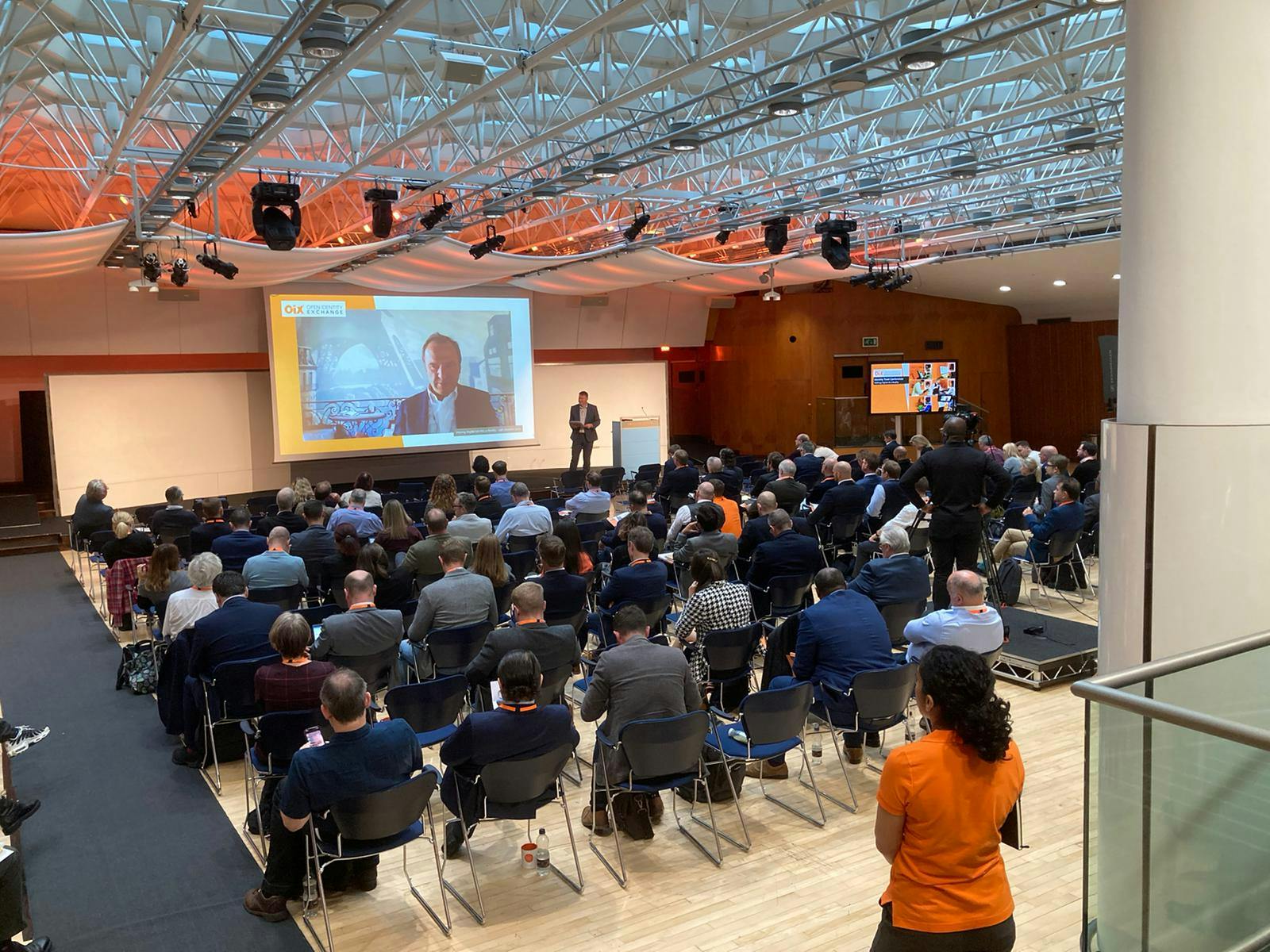 "Congress Hall conference with engaged audience and speaker on stage, showcasing event success."