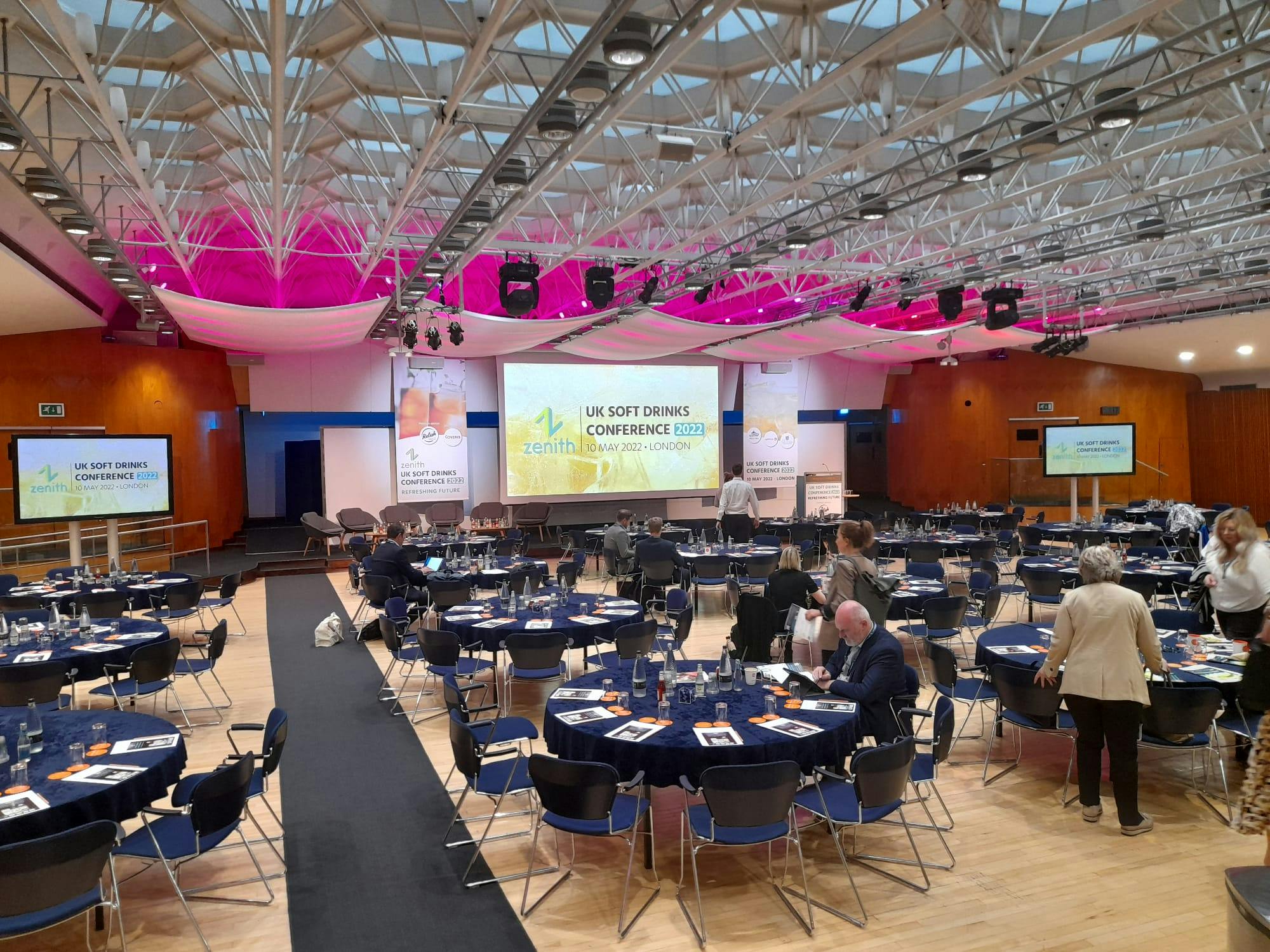 Congress Hall conference setup with blue and white tables, modern AV tech for events.