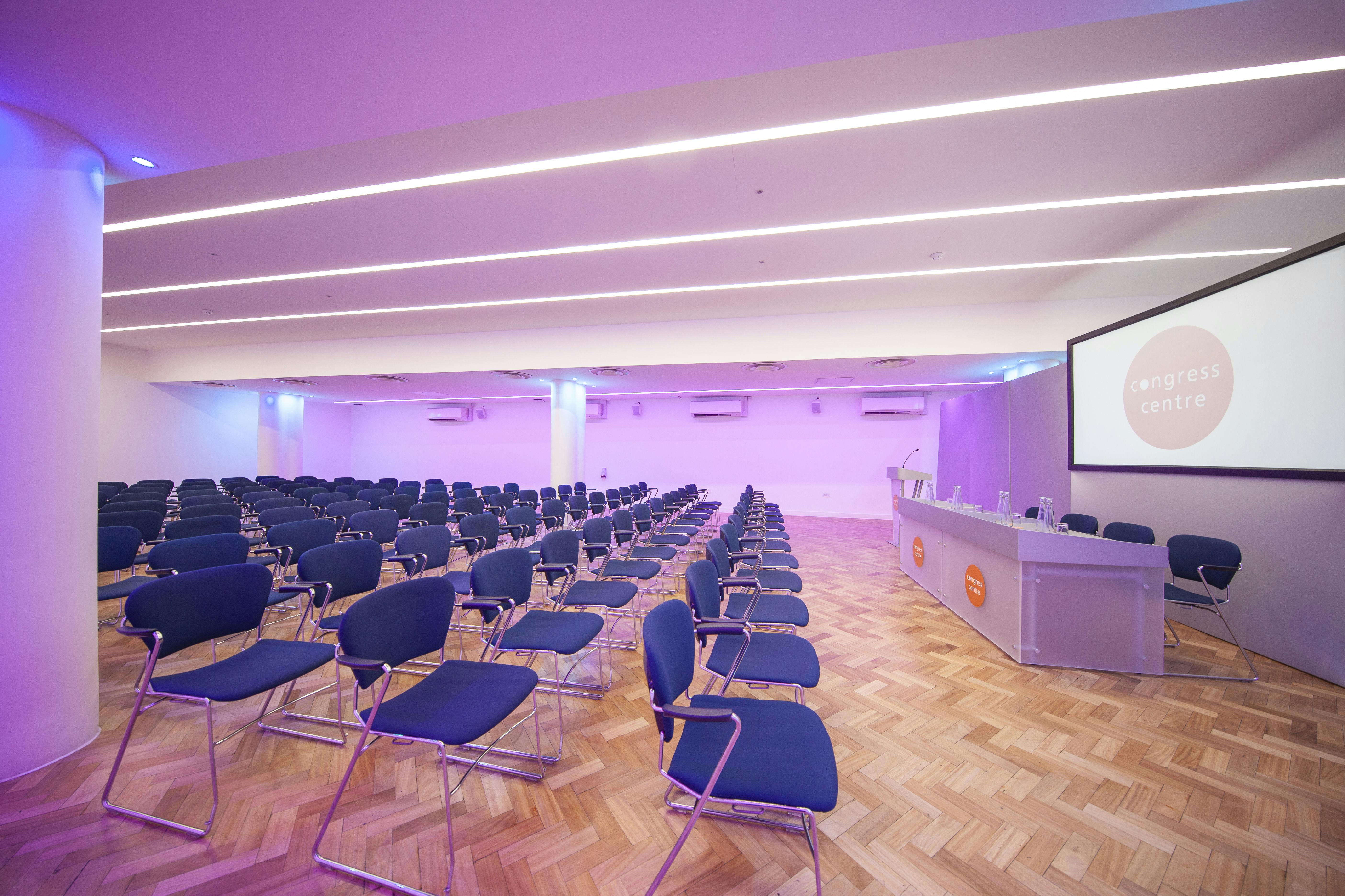 Modern Congress Suite with blue chairs, ideal for conferences and seminars.
