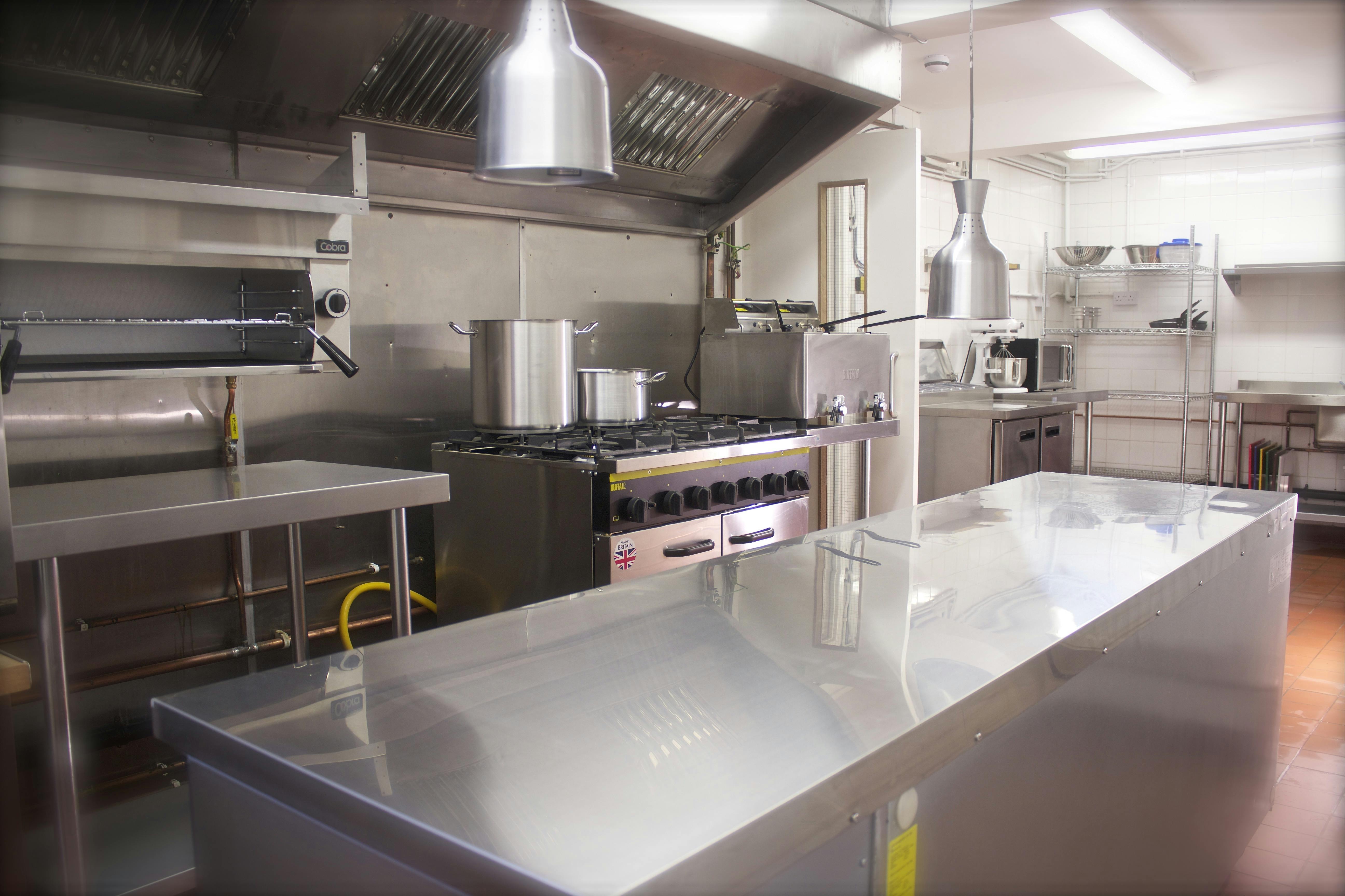 Professional kitchen in Maida Hill Place with stainless steel surfaces for catering events.