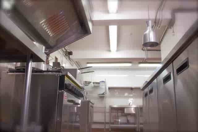 Professional kitchen in Maida Hill Place with stainless steel appliances for catering events.