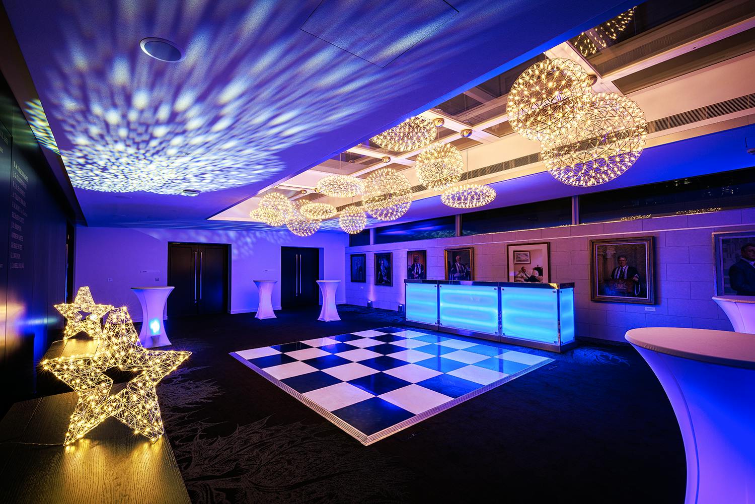 Stylish event space with black and white dance floor, ideal for galas and corporate functions.