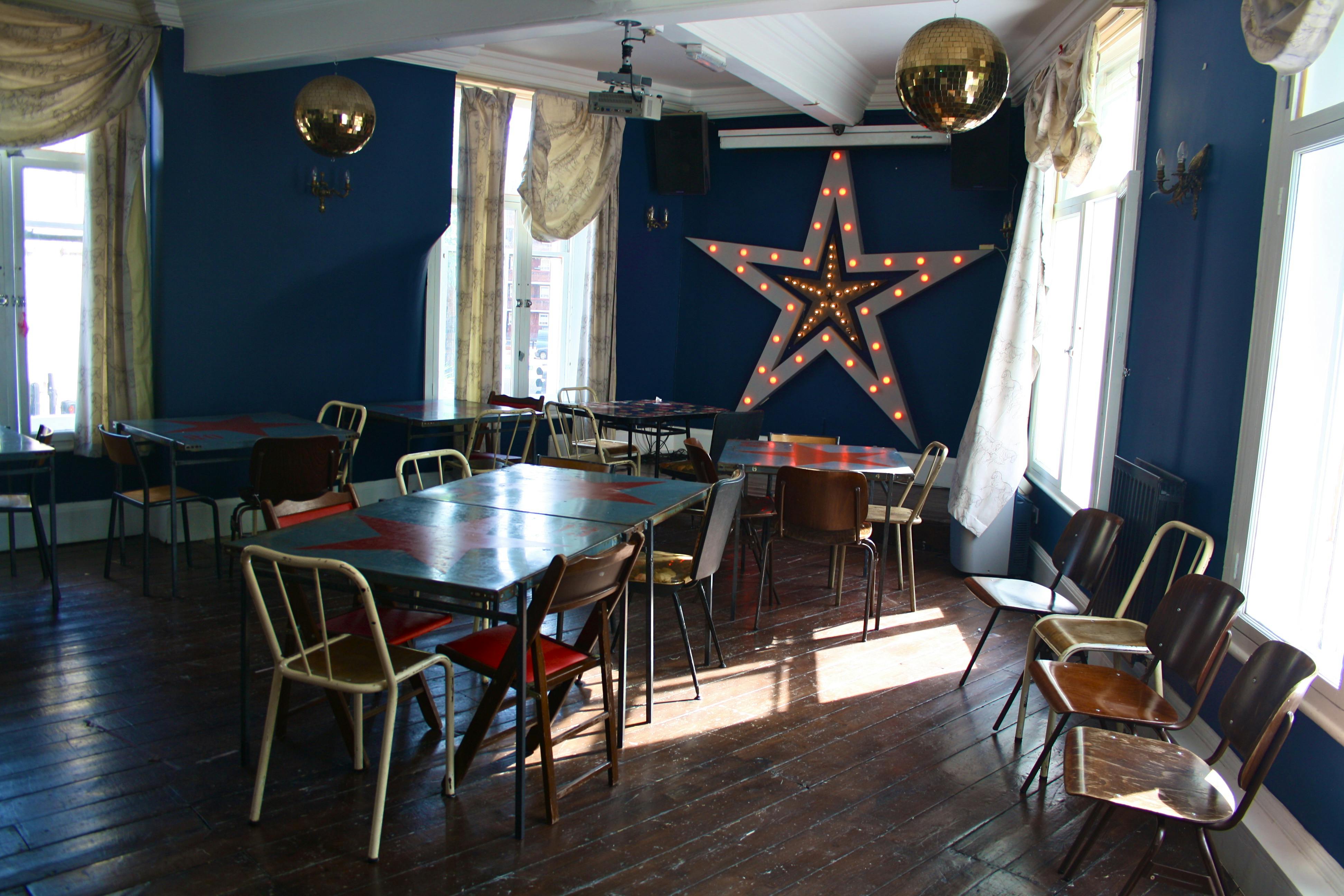 Stylish Upstairs Function Room with star decor, perfect for events and gatherings.