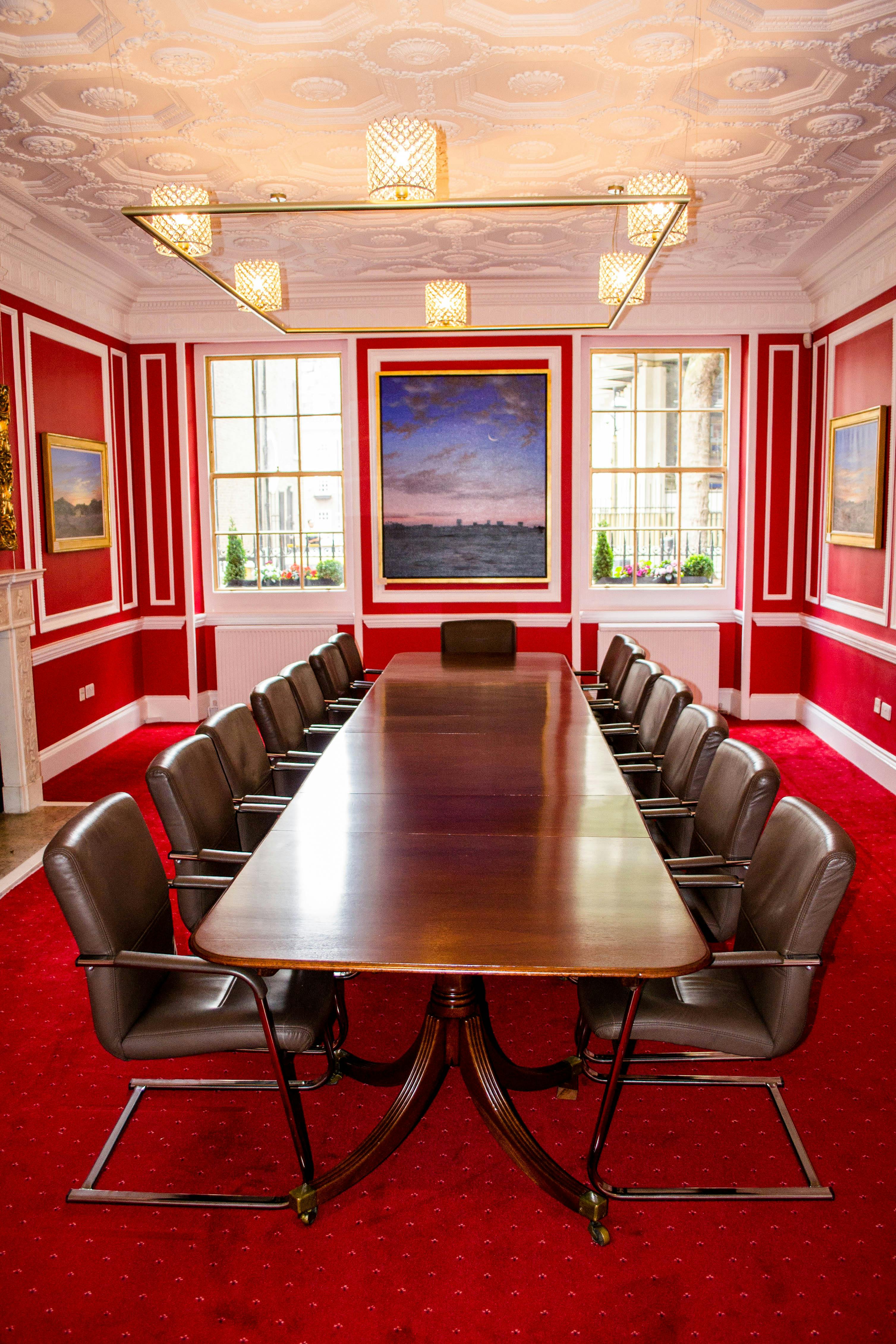 Rose Suite boardroom with wooden table, ideal for executive meetings and strategic planning.