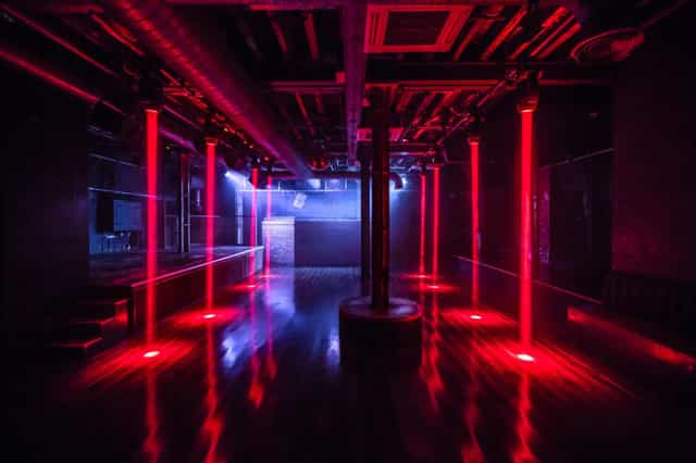 Sleek XOYO venue with red lighting, ideal for events and performances.