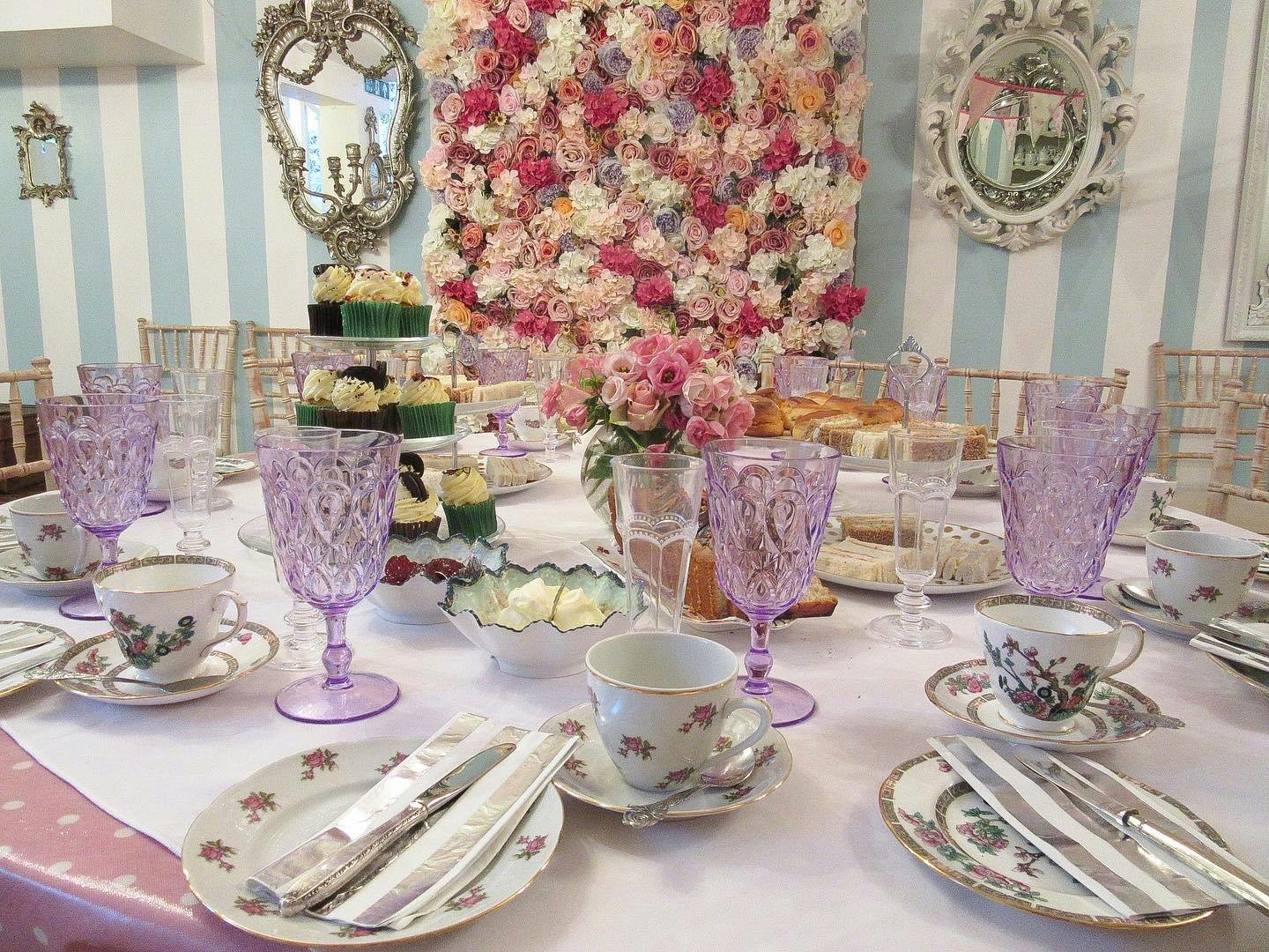 Elegant tea party table with floral arrangements, perfect for bridal showers or afternoon tea.