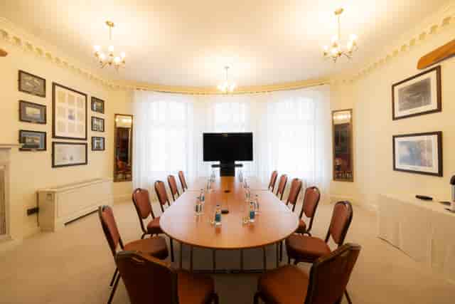 Sopwith Room meeting space with oval table, ideal for professional gatherings and presentations.