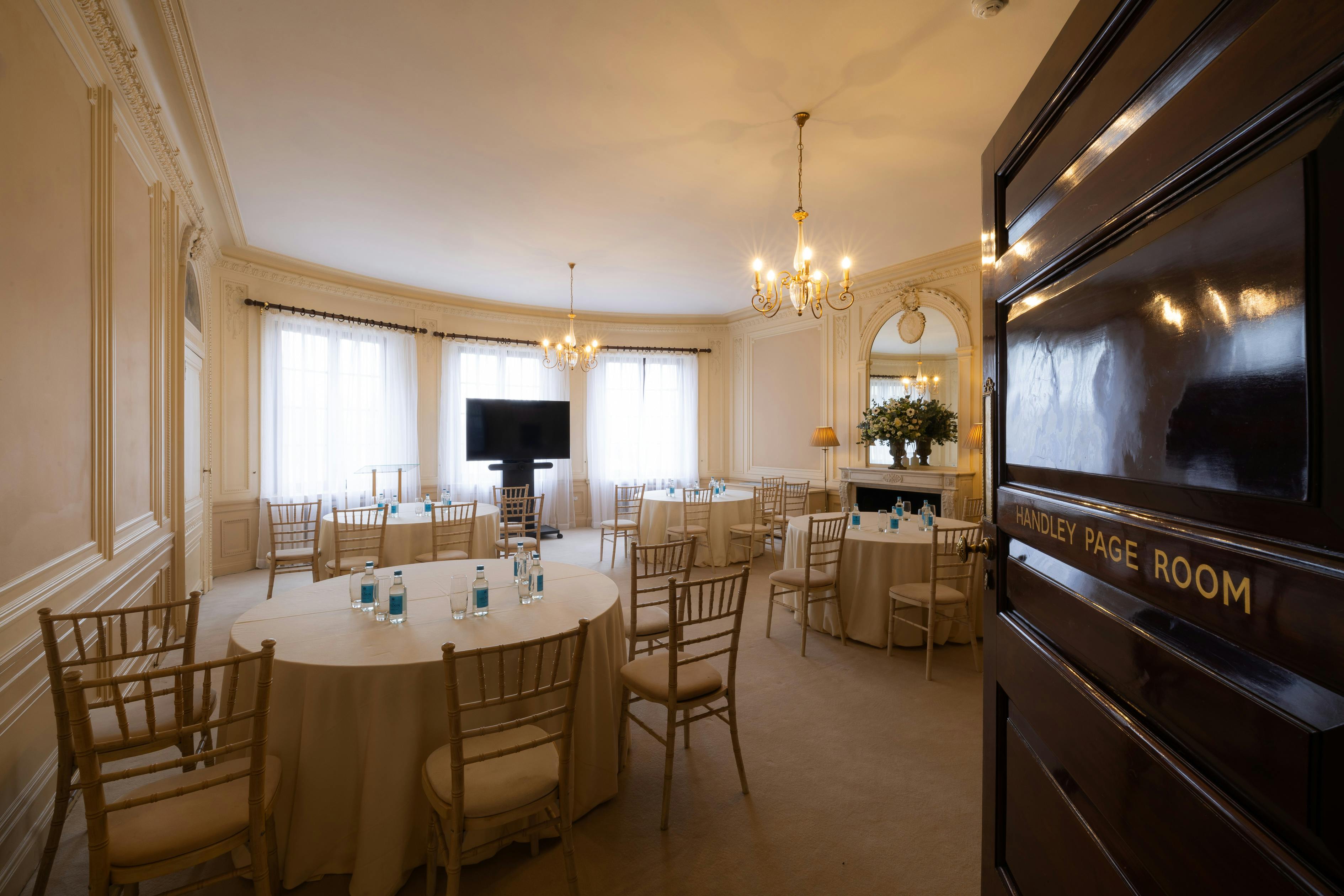 Elegant Handley Page Room with round tables, perfect for corporate events and meetings.