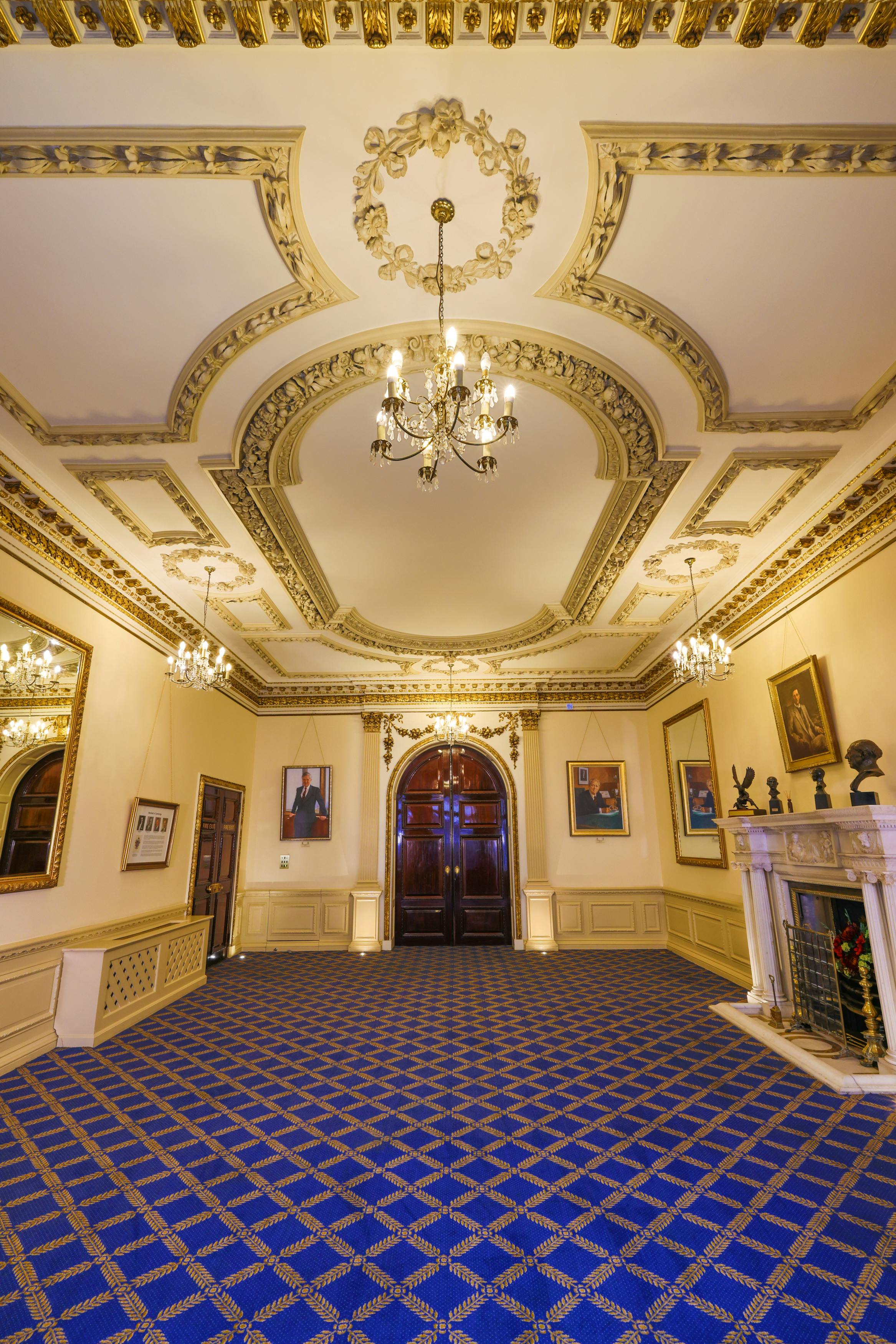 Elegant meeting space with ornate ceiling, ideal for formal events and networking.