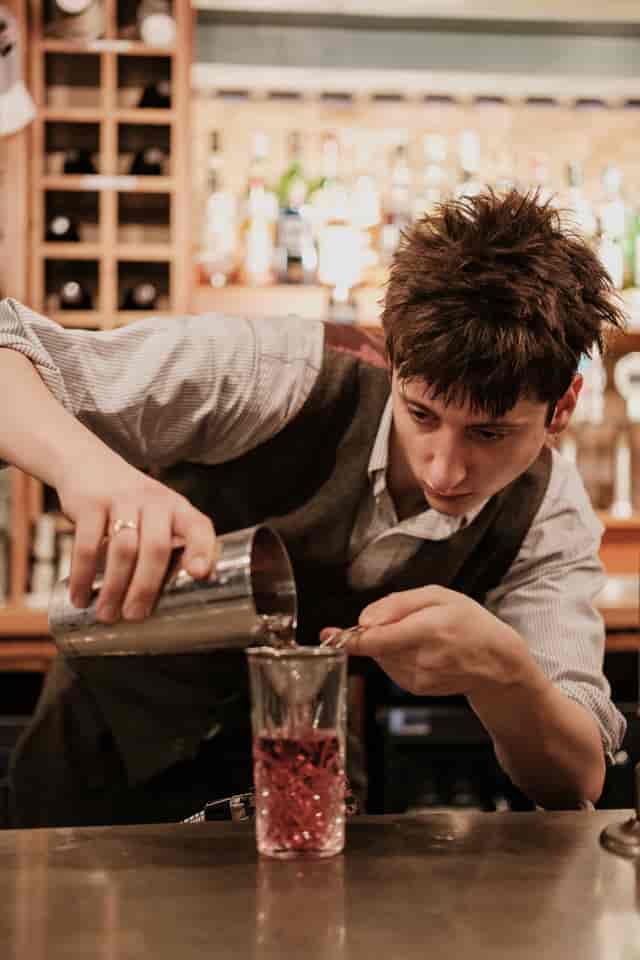 Bartender mixing drinks at Cellar Bar, enhancing events with professional service.
