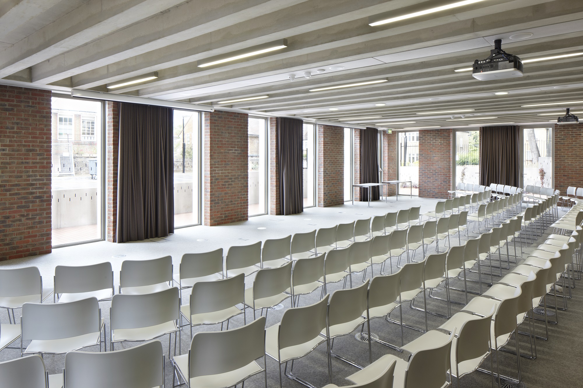 Versatile event space with natural light, ideal for corporate meetings and workshops. - Banner