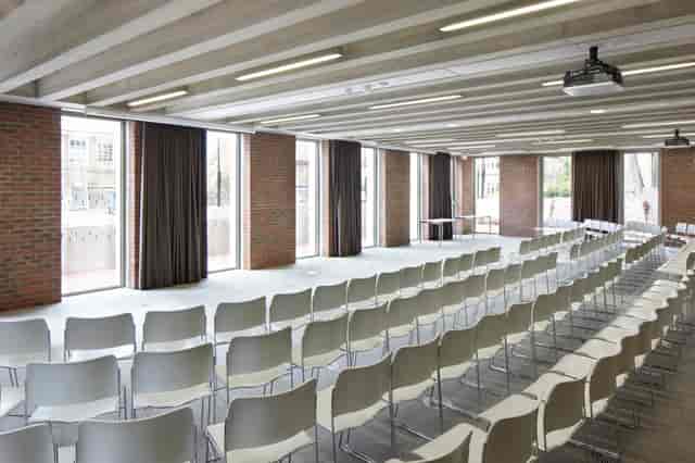 Versatile event space with natural light, ideal for corporate meetings and workshops.