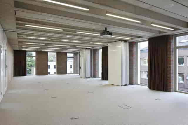 Versatile meeting space with natural light for corporate events and workshops.