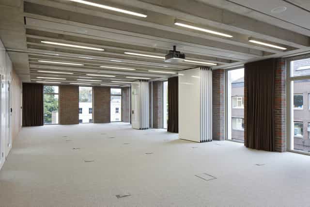 Versatile meeting space with natural light for corporate events and workshops.