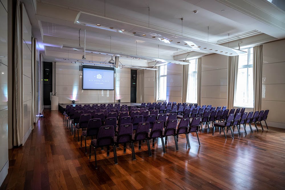 Princess Alexandra Hall with purple chairs, ideal for conferences and presentations.