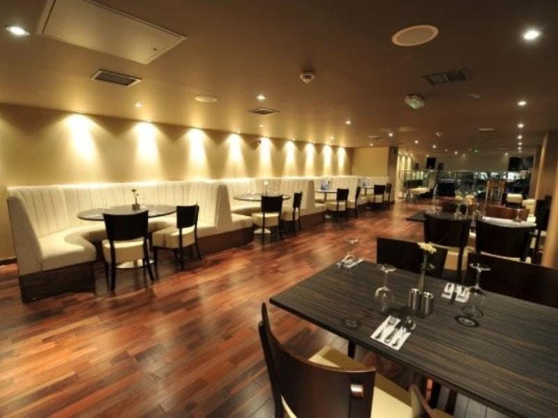 Mezzanine floor at Zouk Tea Bar & Grill, ideal for events with intimate booths and warm lighting.