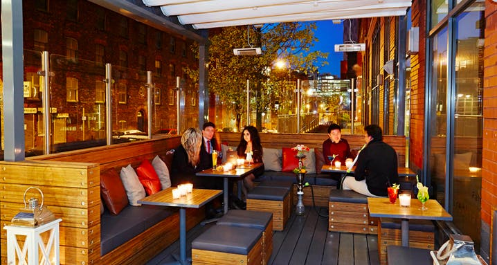 Cozy outdoor lounge at Zouk Tea Bar & Grill, perfect for networking events and gatherings.