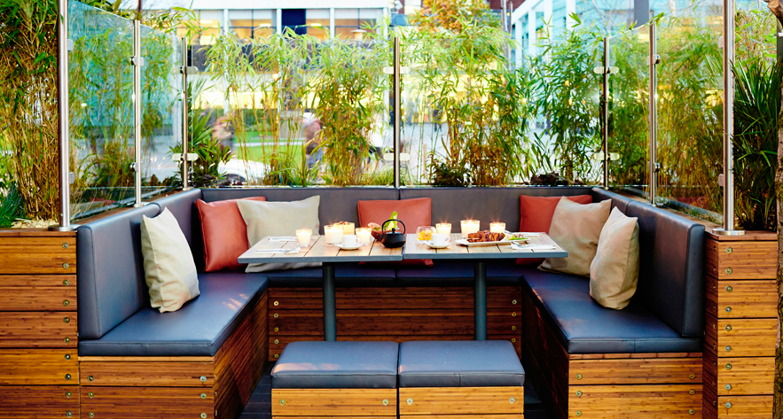 Cozy outdoor seating at Zouk Tea Bar & Grill, perfect for networking events and gatherings. - Banner