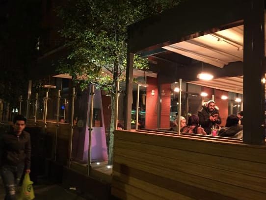 Vibrant outdoor dining at Zouk Tea Bar & Grill, perfect for networking events and gatherings.