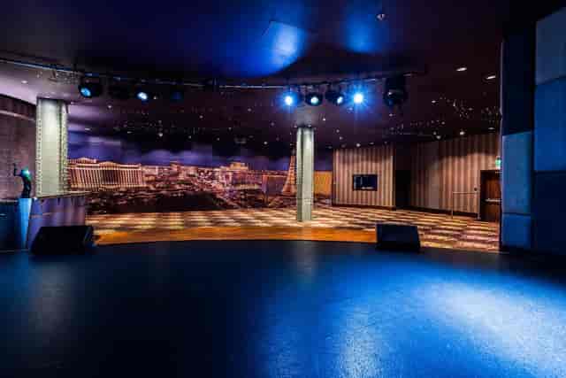 Private Events Suite in Manchester 235 with stage and city skyline, ideal for corporate events.
