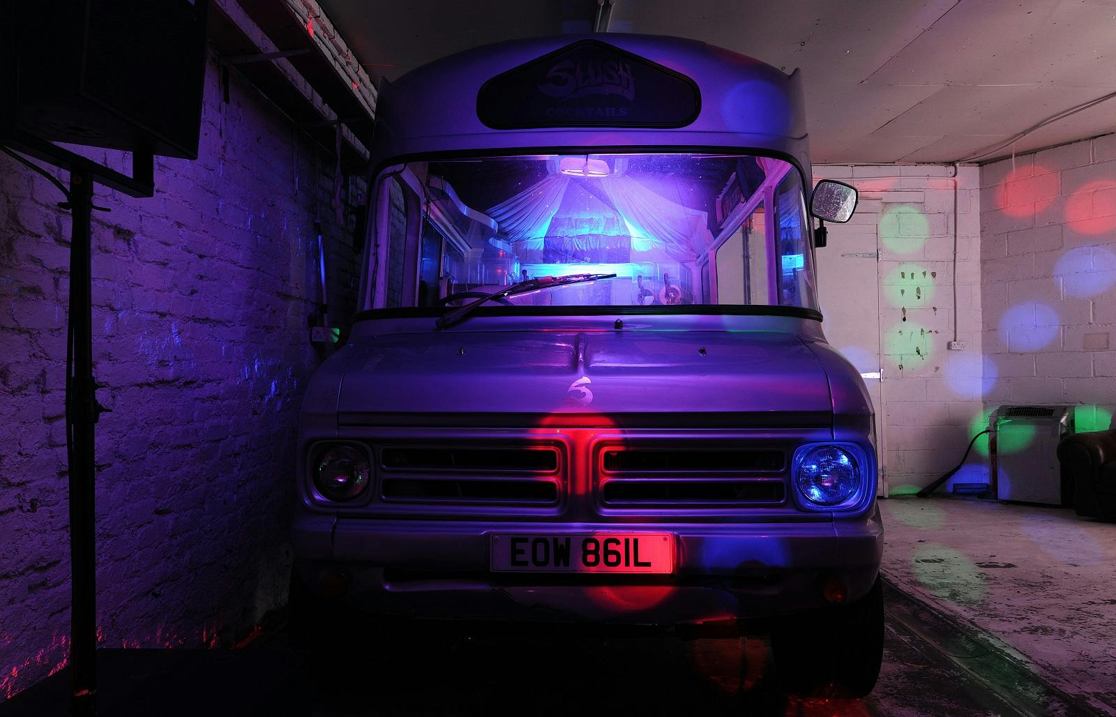 Vintage food truck in vibrant venue, perfect for casual gatherings and themed parties.