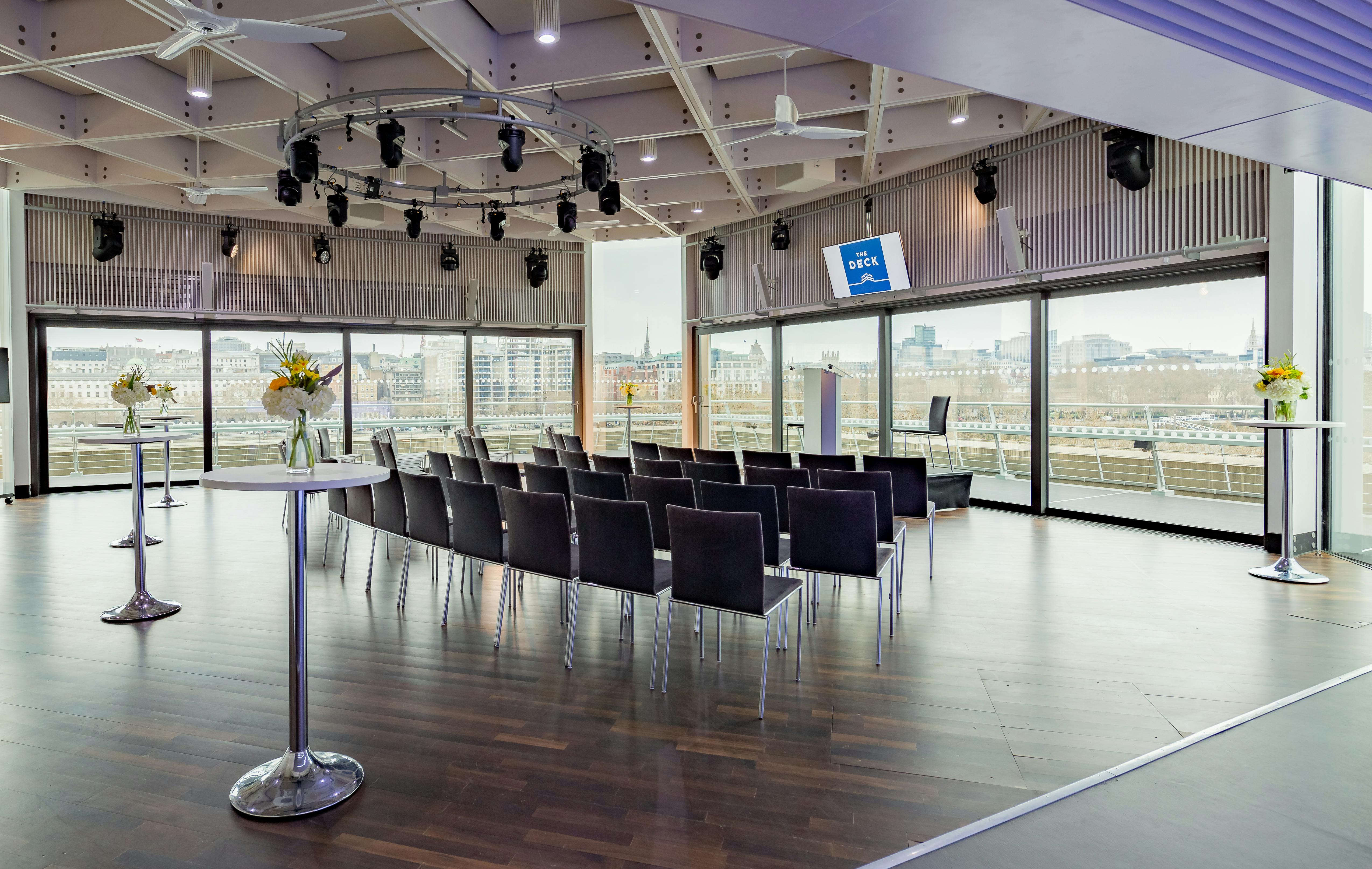 Modern event space with sleek seating and natural light for corporate meetings.