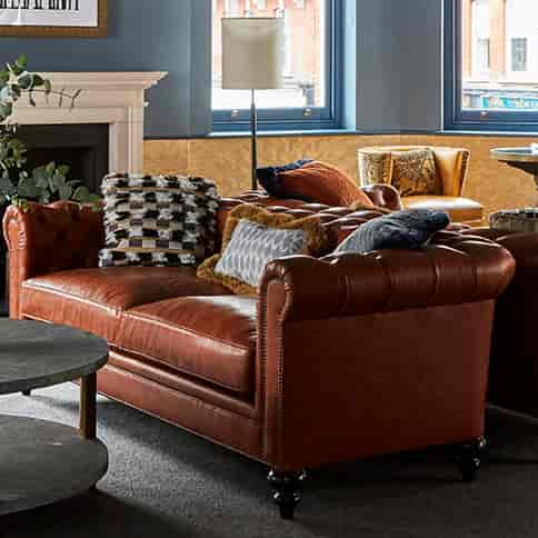 Stylish lounge with plush leather sofa, ideal for networking events at Beaufort House.