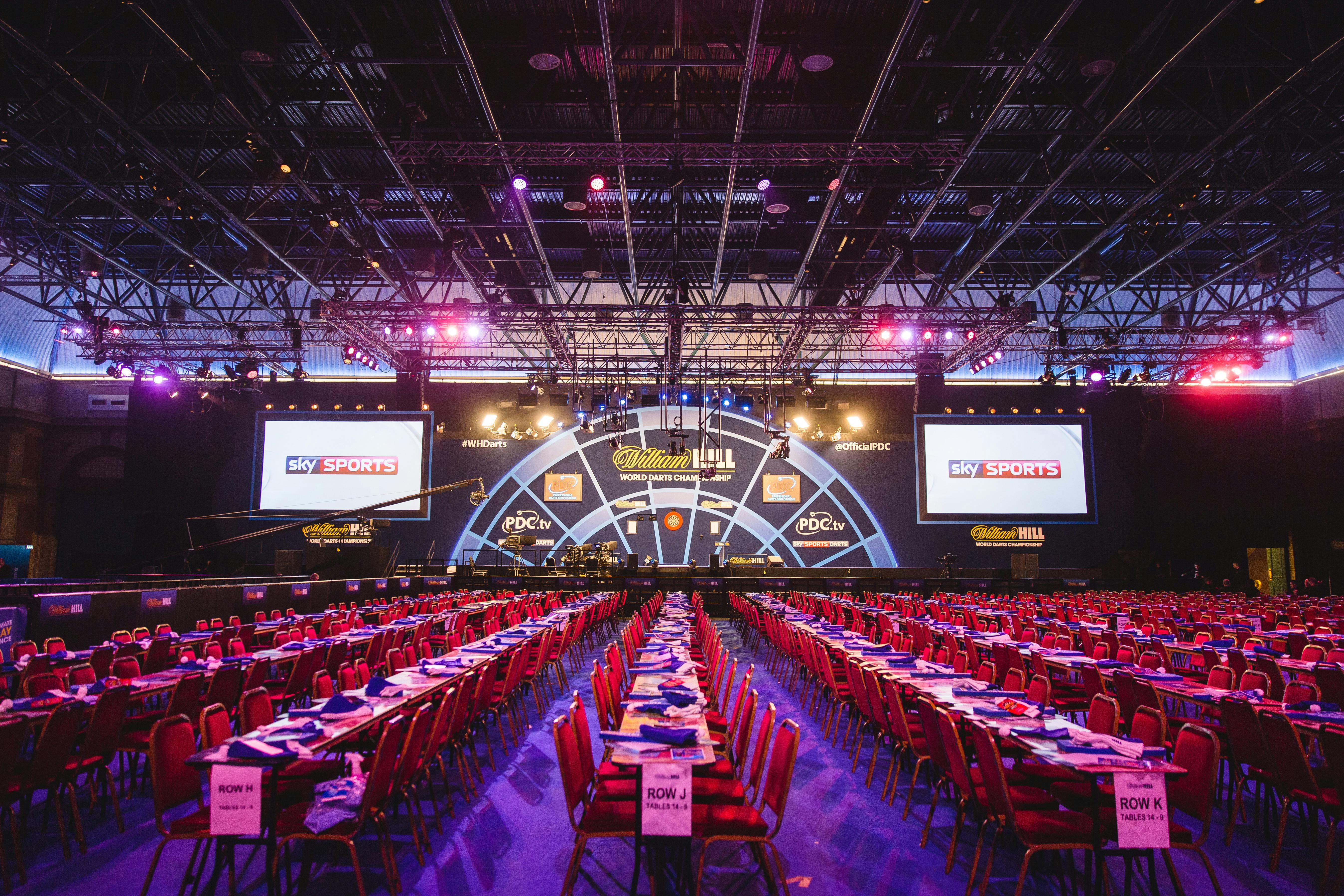 West Hall at Alexandra Palace set for a dynamic conference with vibrant lighting and stage.
