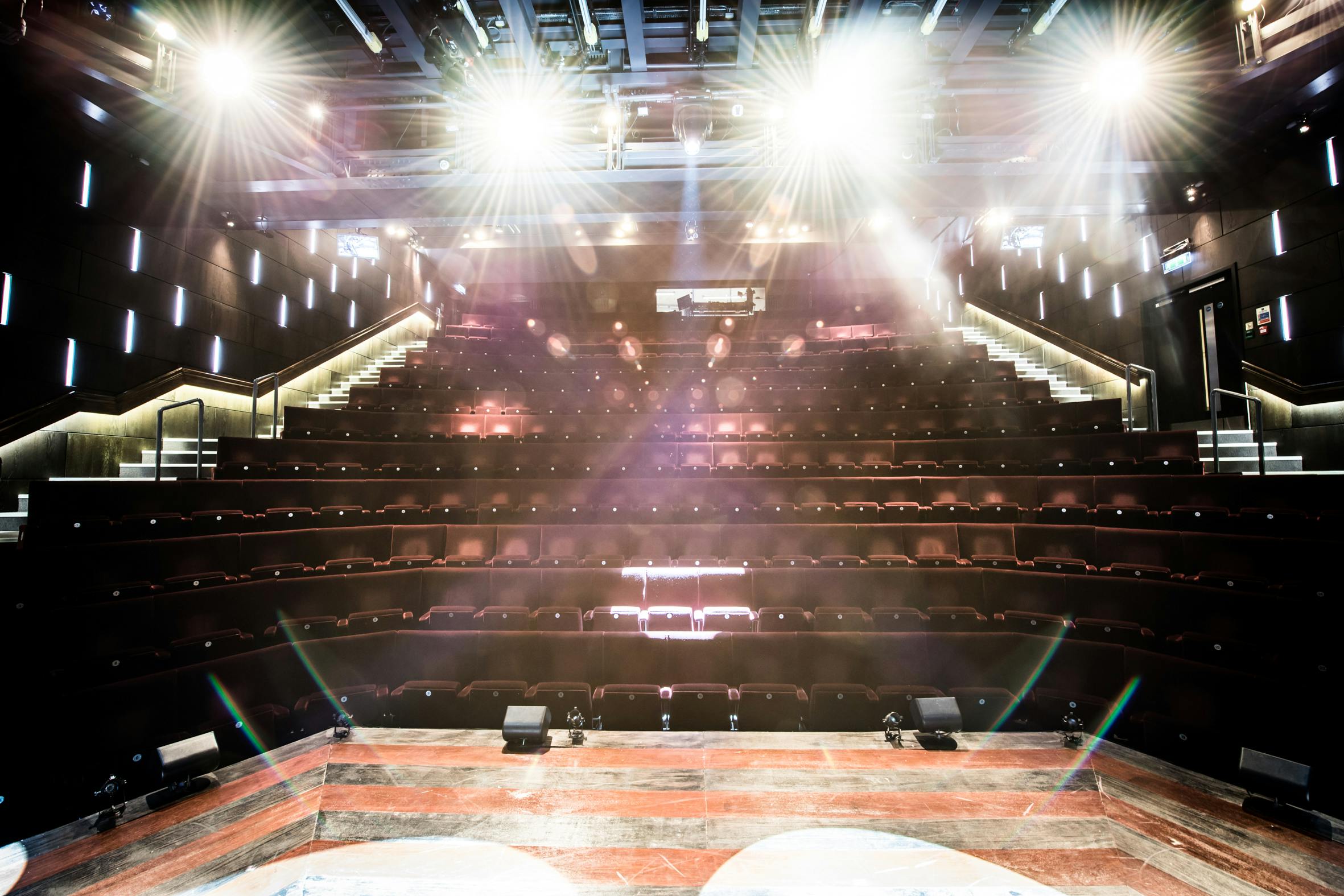 Modern auditorium with tiered seating at The Other Palace Theatre for events and performances.