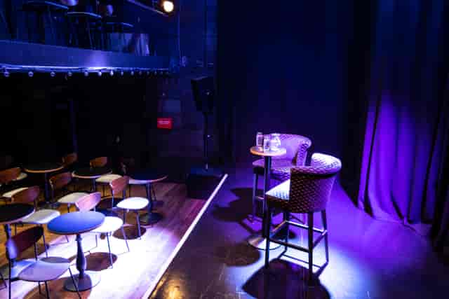 Intimate event space at The Other Palace Theatre with stage and chairs for discussions.
