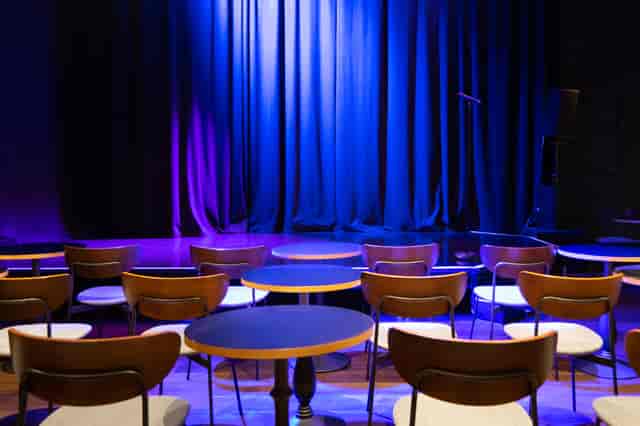 Intimate event space with stage and dramatic lighting at The Other Palace Theatre.