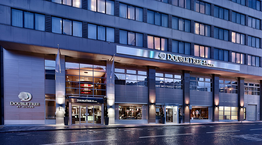 Modern DoubleTree hotel exterior, ideal for corporate meetings and events in Victoria. - Banner