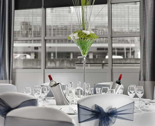 Elegant dining table with floral centerpiece at The National, DoubleTree Victoria event.