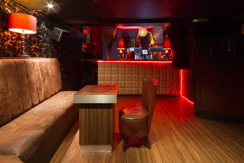 Stylish basement venue with warm lighting for private events and networking gatherings.