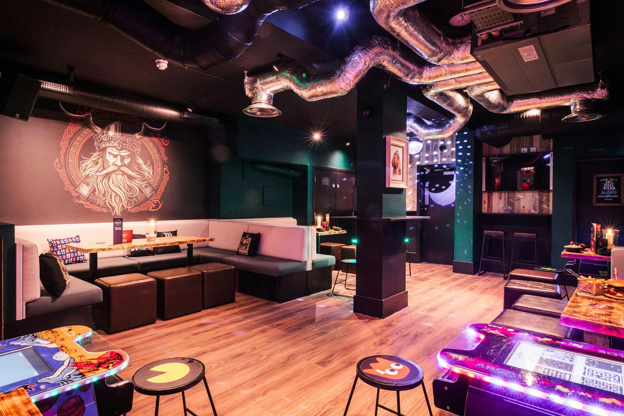 Vibrant Nordic Bar games room with arcade games, ideal for networking events and gatherings.