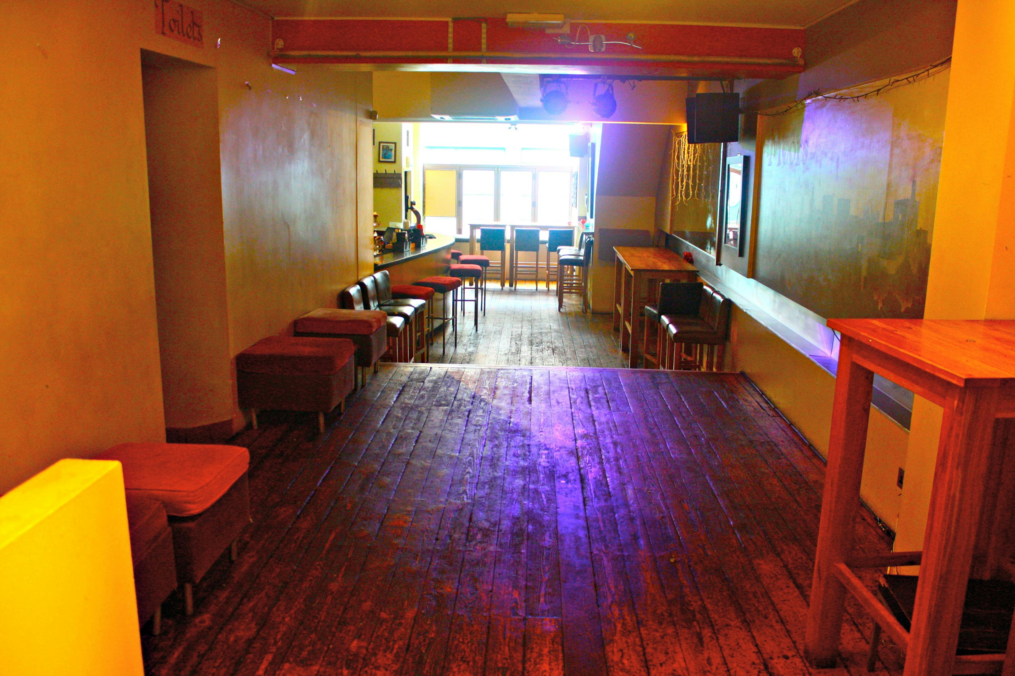 Versatile event space at Moors Bar with wooden flooring, ideal for gatherings and receptions.