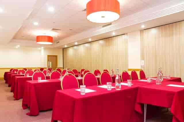 Pimlico 1 classroom setup with red linens for corporate training or workshops.