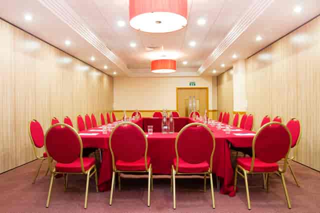 Boardroom setup in Pimlico 2, Clerkenwell Centre with red hollow square seating for meetings.