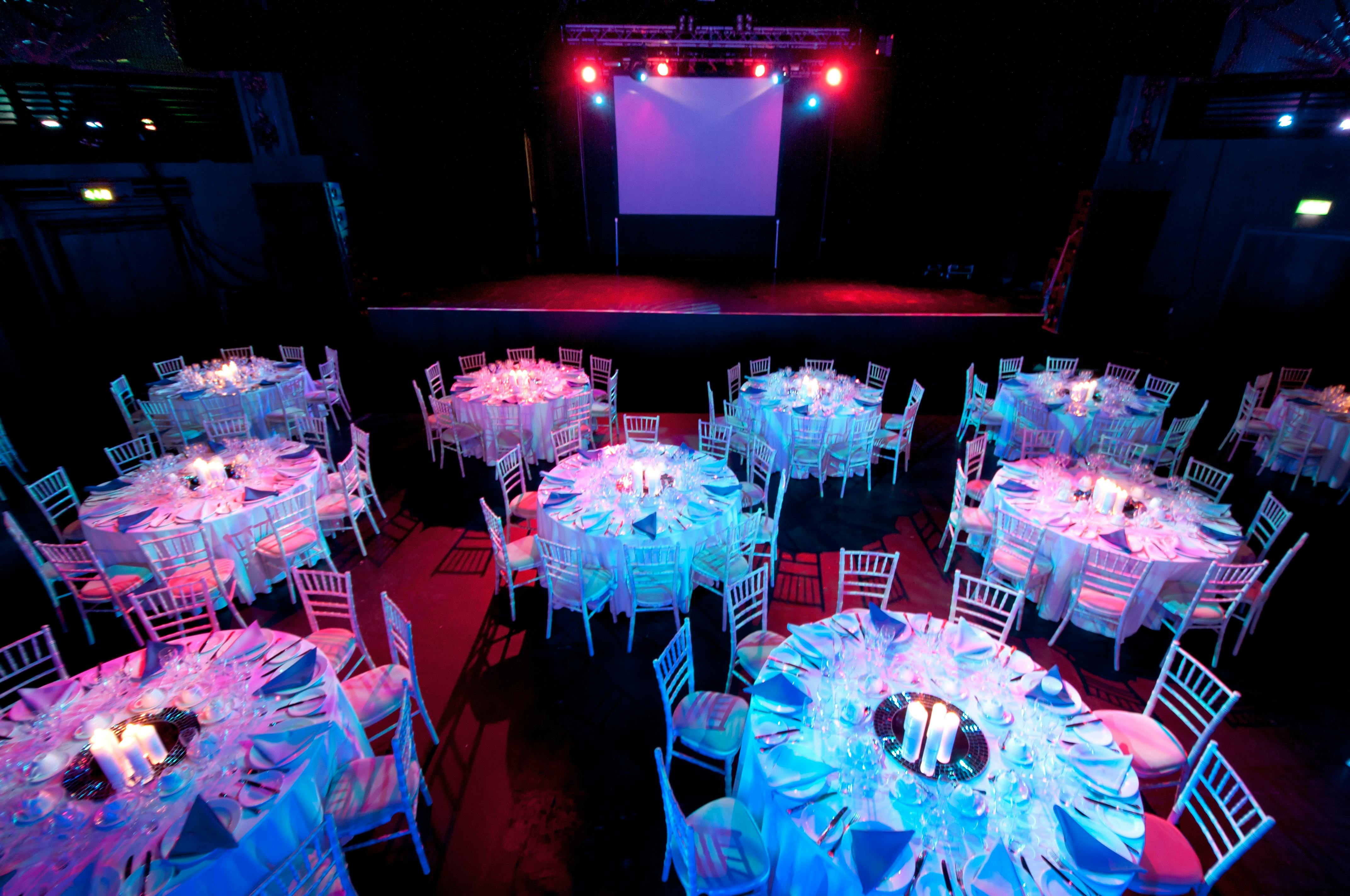 Electric Brixton event space set for formal dinner with elegant tables and vibrant ambiance.