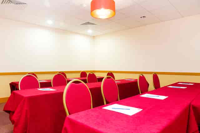 Classroom-style meeting room at Clerkenwell Centre with red linens for corporate events or training.