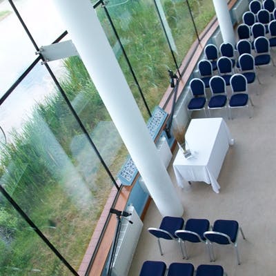 Modern event space with blue chairs at WWT London Wetland Centre for meetings and workshops.