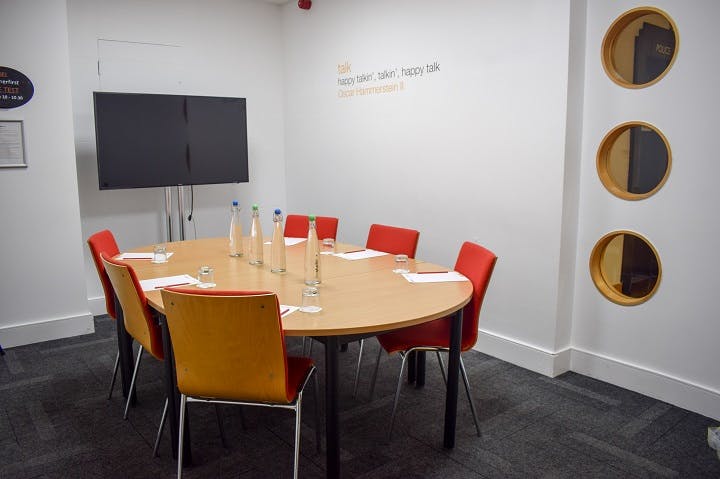 Modern meeting room in Birmingham with round table for collaborative brainstorming sessions.