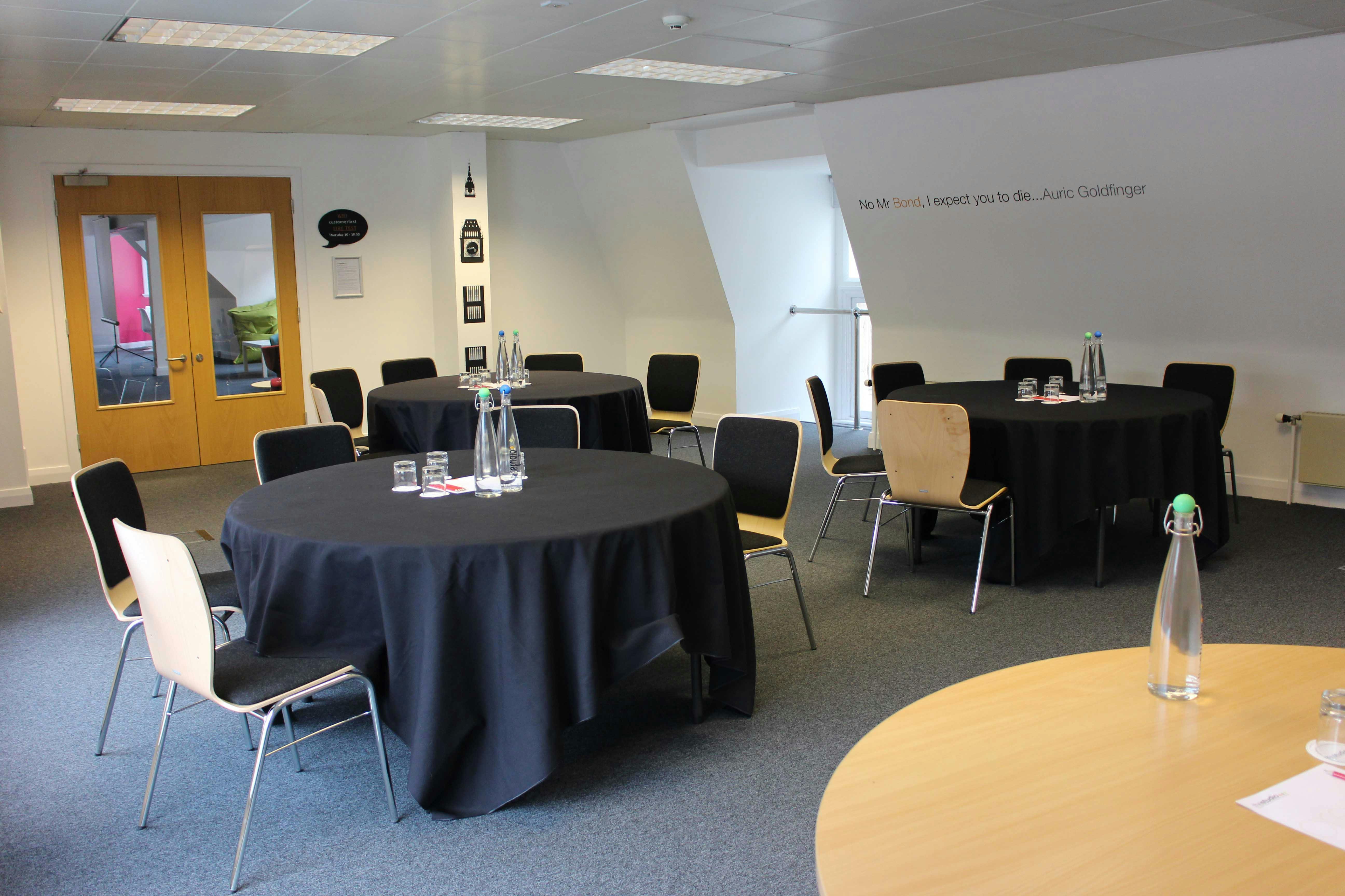 Versatile meeting space in Birmingham with round tables for workshops and conferences.