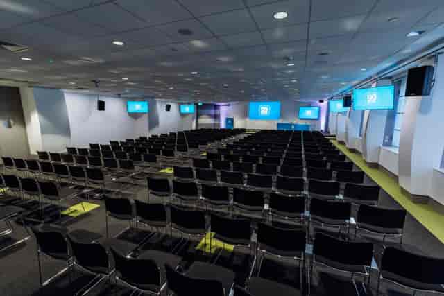 Theatre-style Constellation Suite at 99 City Road with digital displays for corporate conferences.
