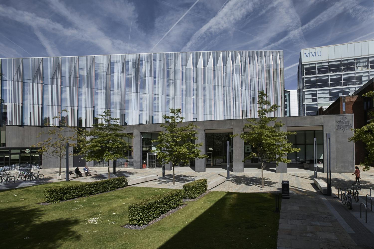 Modern Business School Atrium with glass facade, perfect for conferences and events.