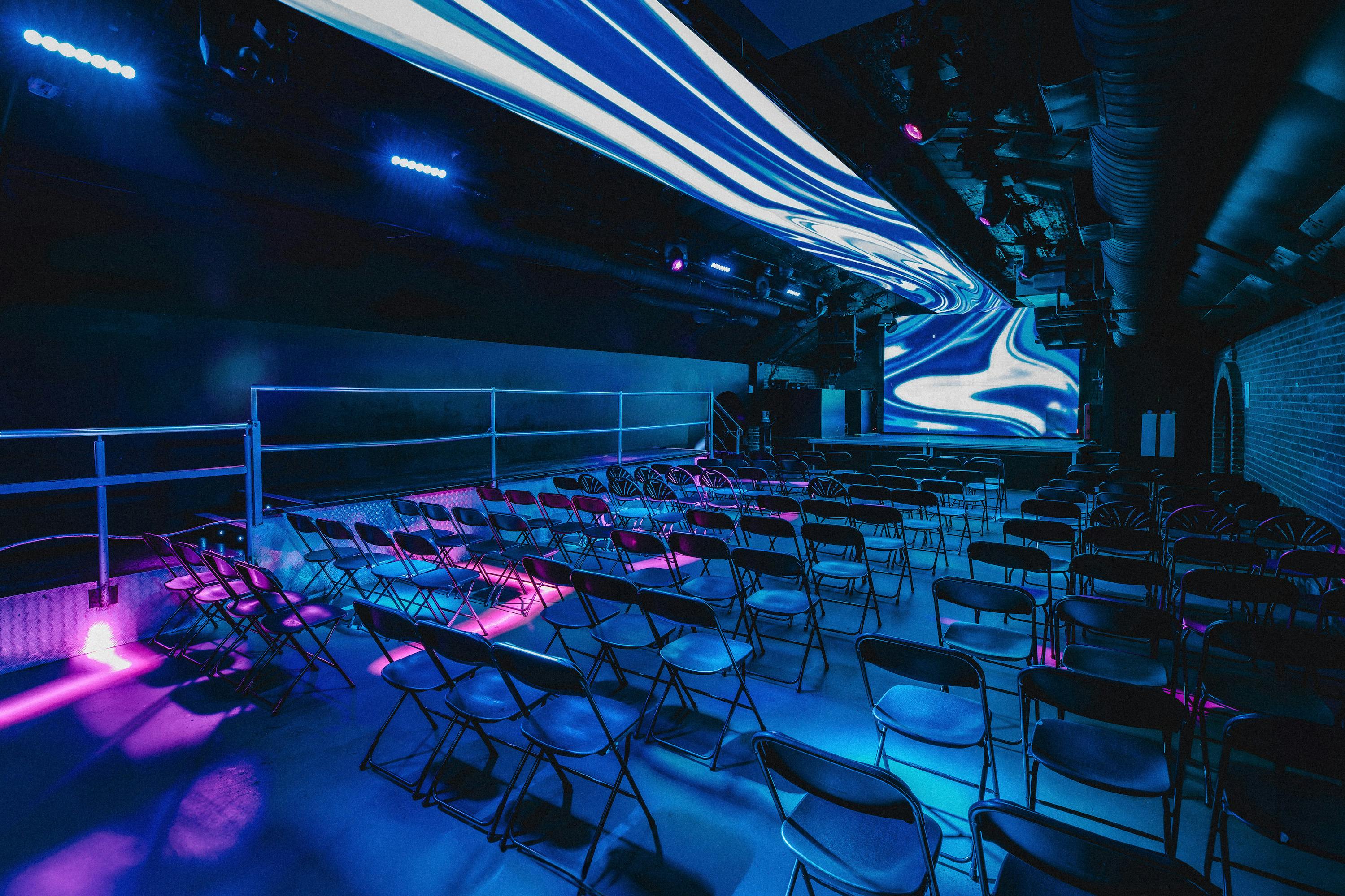 Fire in Vauxhall Arches: modern event space with LED backdrop for conferences and creative events.