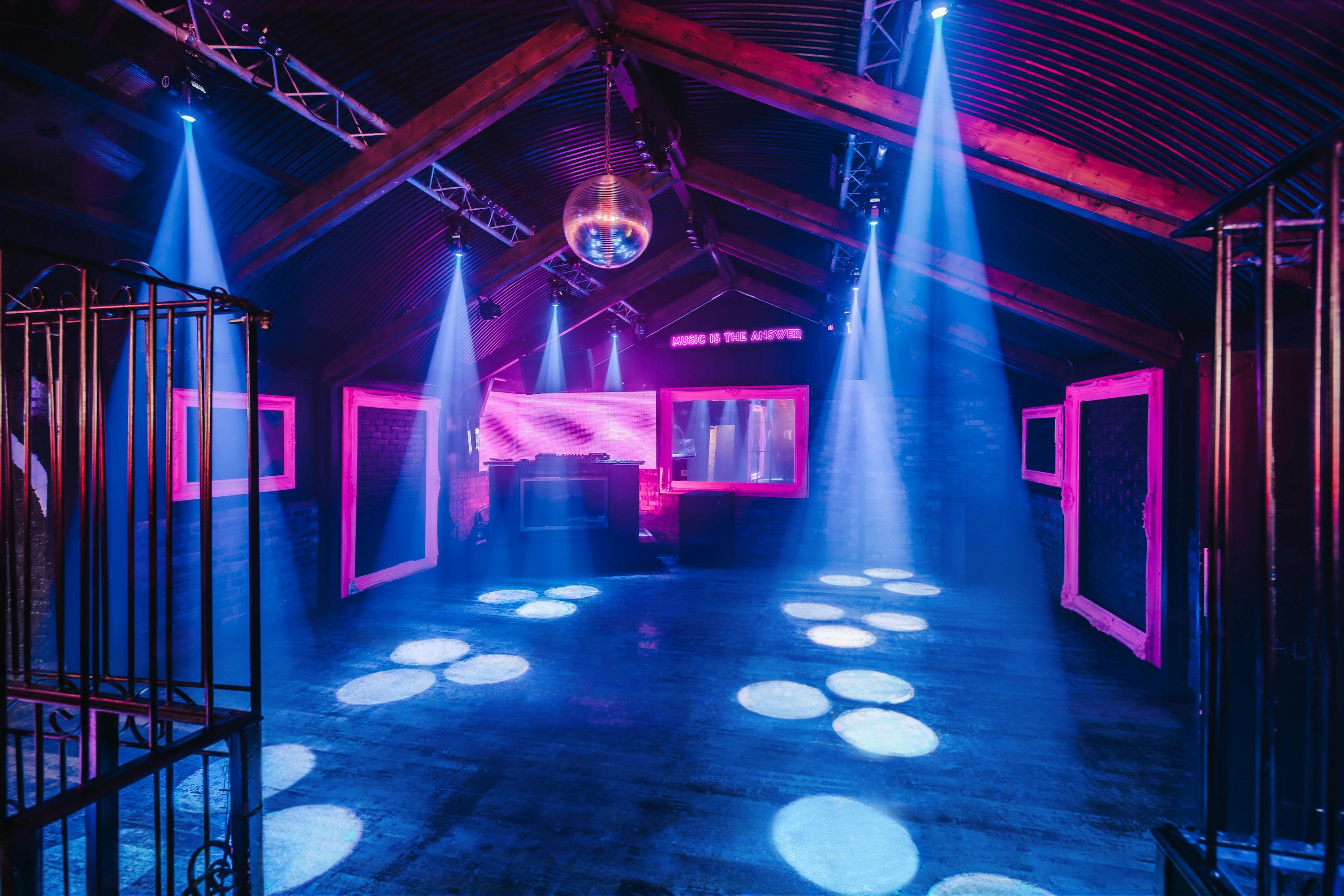 Vibrant Vauxhall Arches event space with disco ball for parties and corporate events.