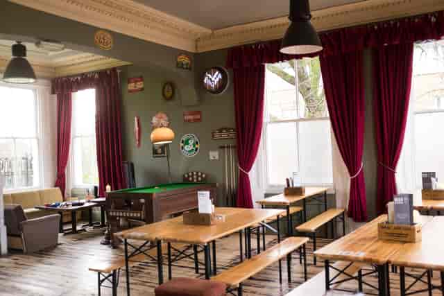 Cozy function room with rustic decor, ideal for casual events and team-building activities.